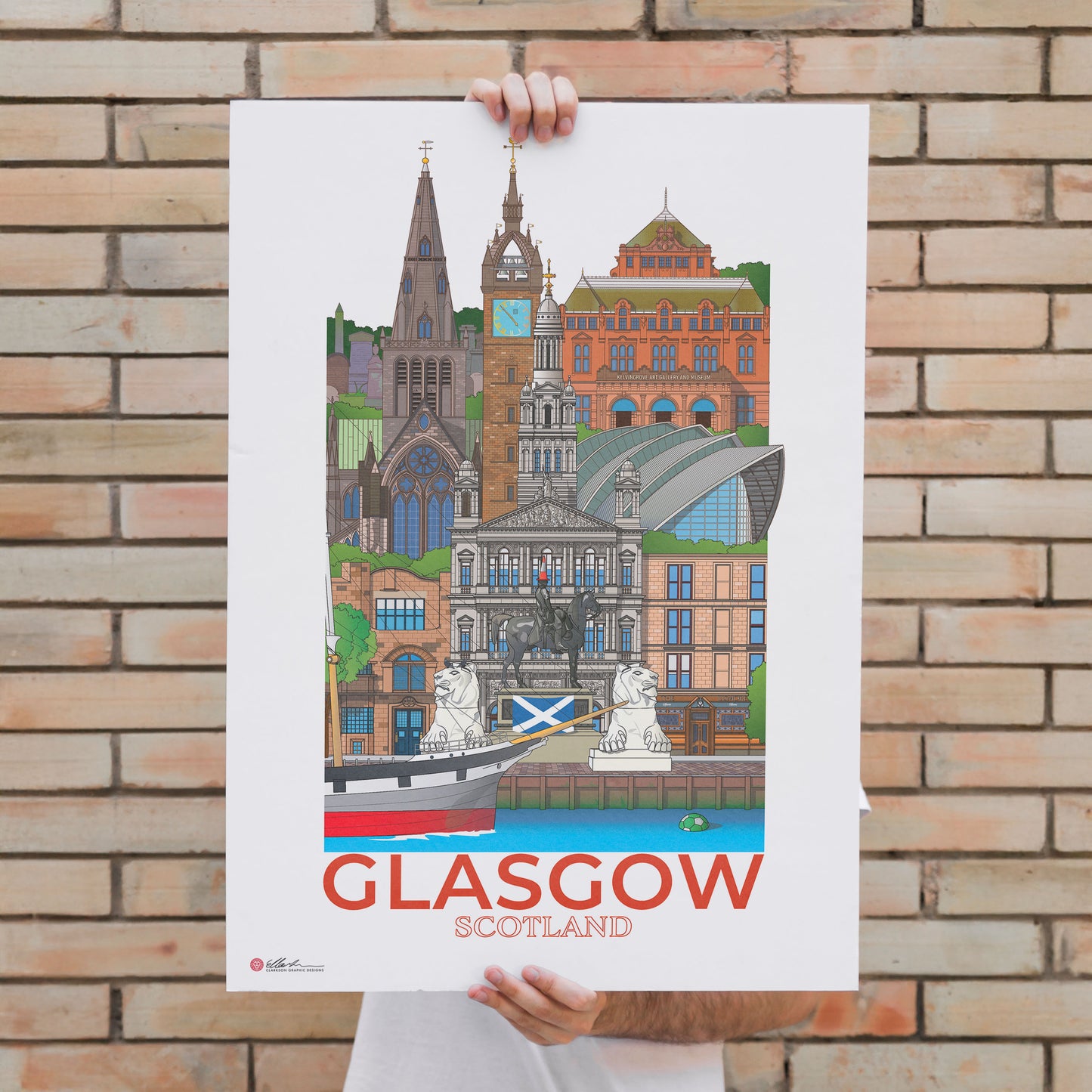 Person holding a poster of Glasgow, Scotland against a brick wall.